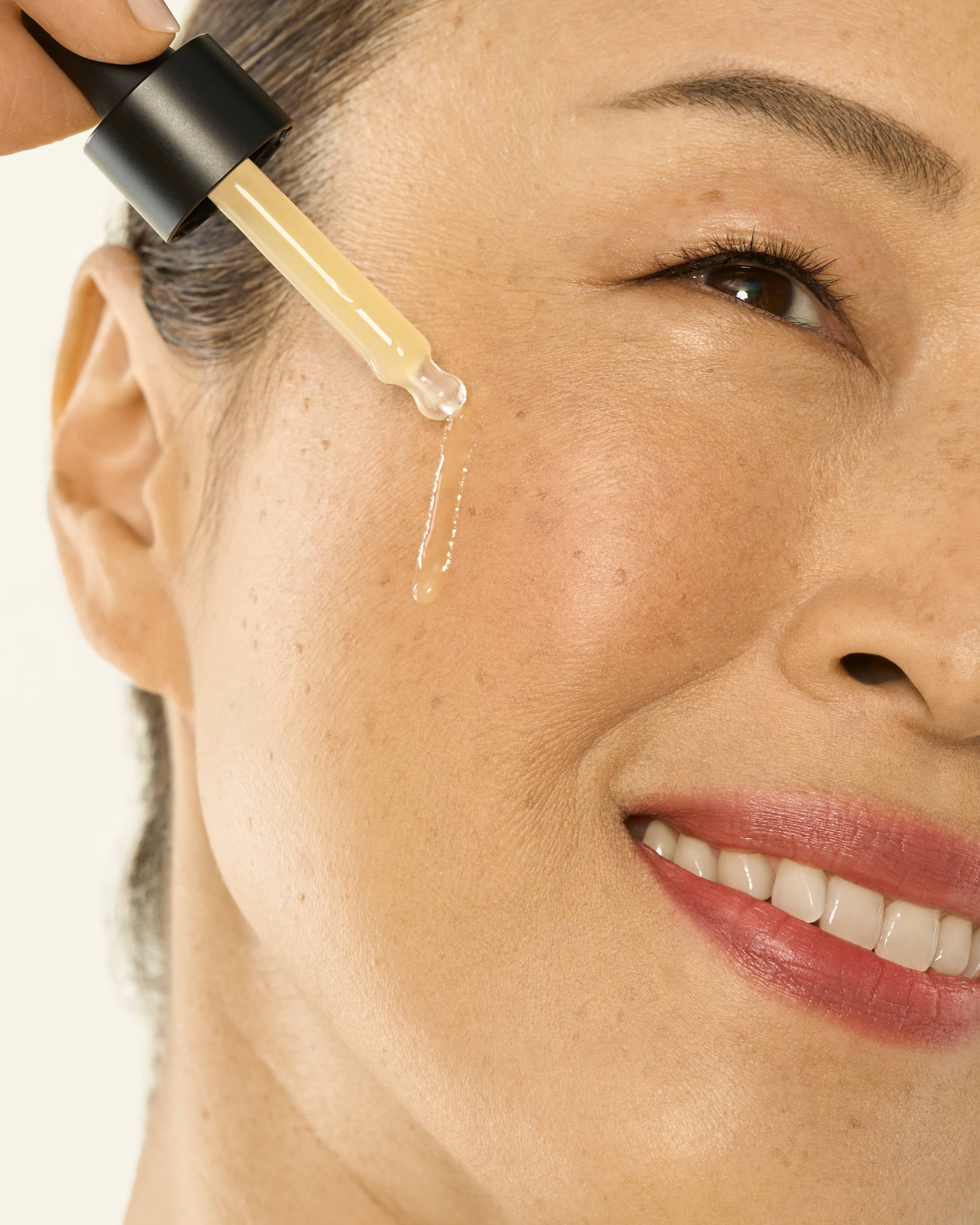 Woman applying peptide serum