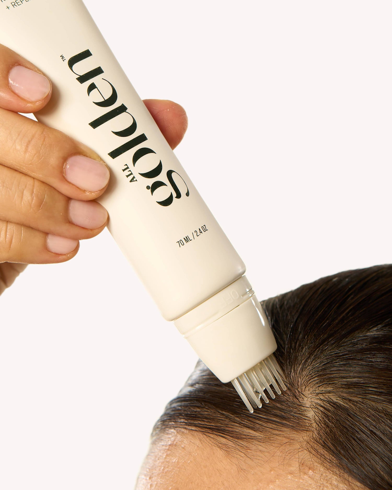 woman applying root changer