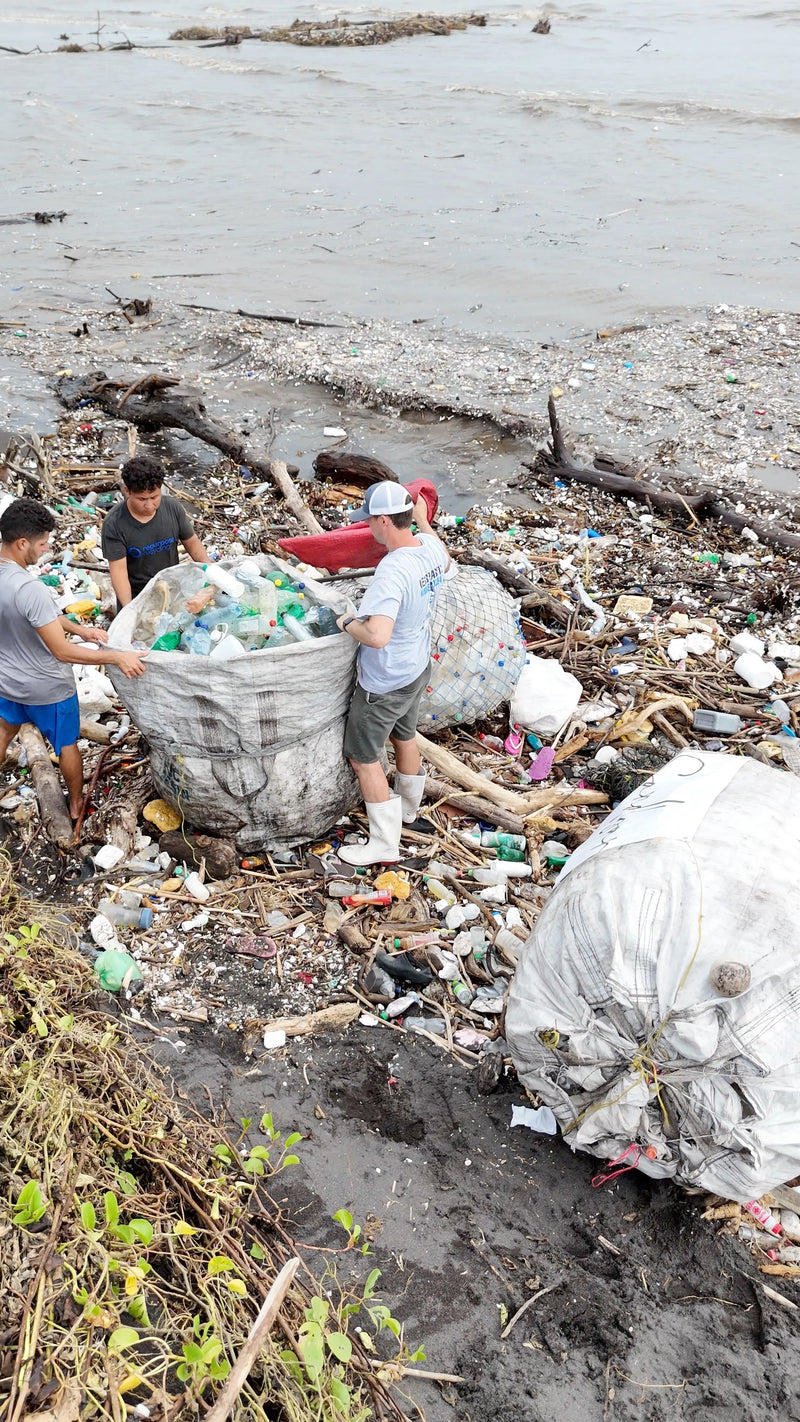 Man from Tidey Oceans picking up trash on the beach