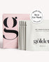 Shape All Golden eye mask sachets and packaging on a clean white background, featuring a pink box with a large black logo and a stack of white individual packets with a &