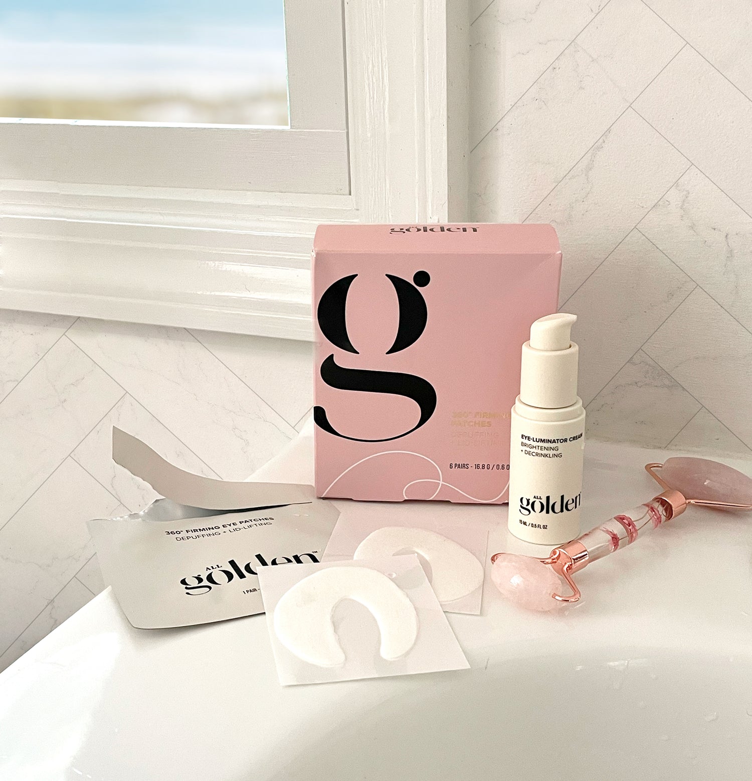 Jade Roller, Eye Patches, and Eye cream on a bathroom sink